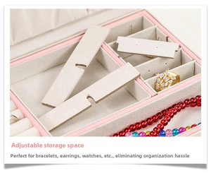 Detail of jewelry box interior featuring adjustable compartments and soft beige velvet lining