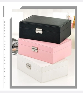 Vertical stack of double-layer leather jewelry boxes in black, pink, and white finishes