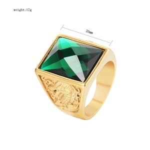 Macro view of 20mm men's gold-plated titanium ring with large square green gemstone