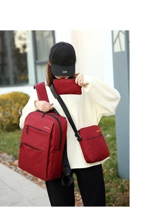 Three-piece red business backpack set including shoulder bag and pouch in outdoor setting
