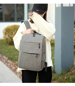 Detail shot of a grey waterproof business backpack showing zippers and durable fabric texture