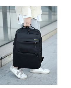 Close-up of a black waterproof business backpack with multiple zipper compartments