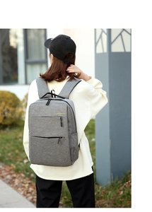 Gray oxford backpack featuring reinforced padded straps and a yellow BACKPACK logo