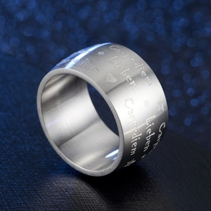 Matte silver Carpe Diem and Lieben engraved stainless steel ring on blue starry background