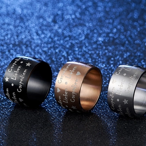 Macro view of brushed matte black and rose gold stainless steel rings with engravings