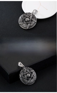 Macro view of vintage titanium steel pentagram pendant with detailed Celtic knot patterns