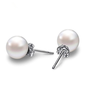 Close-up of elegant 925 sterling silver pearl stud earrings with a glossy white finish