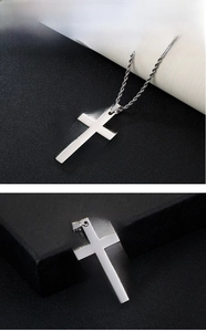 Detailed macro view of polished stainless steel cross pendant with twisted rope chain