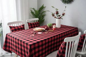 Detailed texture of red and black buffalo plaid table runner with festive holiday accents