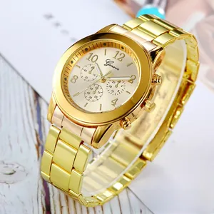 Close-up of Geneva gold-tone watch dial with three decorative sub-dials and metal strap