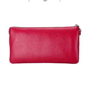 Detail view of red lychee leather texture and 30mm thickness on a small crossbody bag