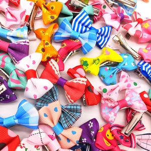 Detailed set of colorful grosgrain ribbon bow clips with various patterns for pets