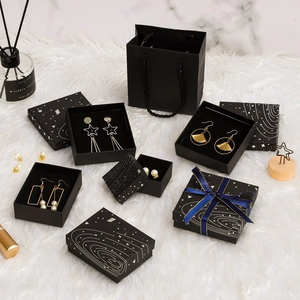 Elegant black jewelry gift boxes with cosmic patterns and matching paper tote bag