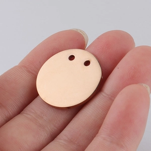 Polished rose gold oval stainless steel pendant with double holes shown on hand