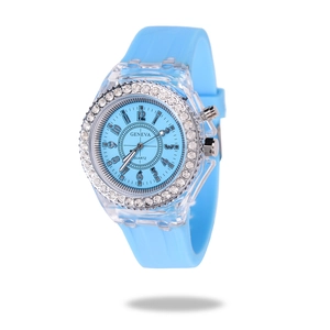 Detailed close-up of light blue quartz watch with rhinestone bezel and silicone strap