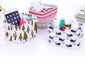 Three cotton linen storage baskets featuring forest, whale, and geometric prints