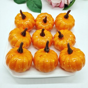 Top view of nine realistic orange foam pumpkins arranged in a white tray for decor