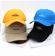 Detailed display of corduroy baseball caps in yellow, khaki, blue, and black colors