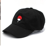 Detail view of cotton baseball cap with red and white embroidered fan pattern on black fabric