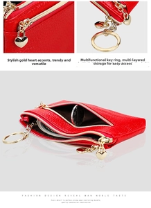Detail of red pebbled leather coin purse with heart pendant and multi-layer zipper