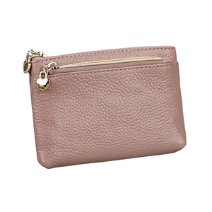 Detail of pink lychee grain leather wallet with a gold heart shaped zipper puller