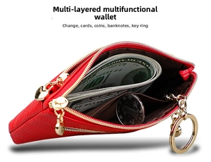 Detail view of red pebble leather purse showing dual heart zippers and internal coin storage