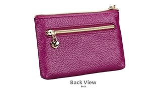 Macro shot of rose purple pebble leather coin purse featuring a gold heart pendant zip