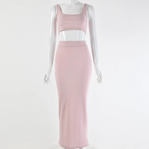 Detail view of pink knitted two-piece set featuring cropped tank top and high waist maxi skirt