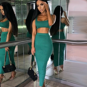 Detail of emerald green ribbed knit two-piece set featuring crop top and midi skirt