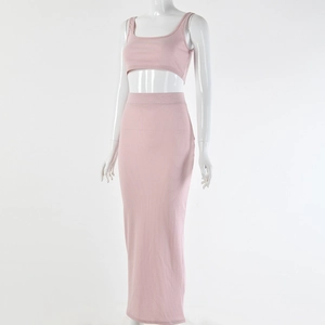 Detail of pink ribbed knit two-piece set featuring cropped camisole and high-waist maxi skirt