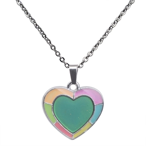 Macro detail of heart pendant necklace featuring colorful rainbow mosaic enamel border