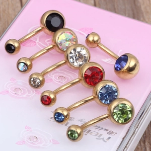 Close-up of gold-plated belly rings with colorful zircon gems in various vivid colors
