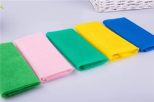 Detailed view of long exfoliating nylon bath towels in various bright colors