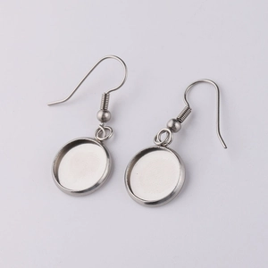 Detail of silver stainless steel earring hooks with round blank bezel settings for DIY