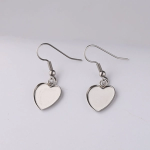 Close-up of heart-shaped silver stainless steel earring hooks for jewelry making
