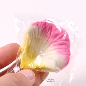 Macro shot of realistic artificial silk rose petals with pink and yellow gradient effect