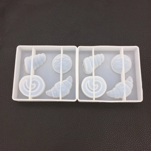 Detailed view of two-piece white silicone molds for pastry and bread resin pendants