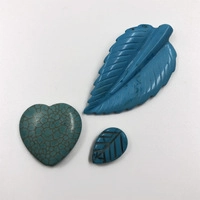 Flat lay of turquoise beads in leaf and heart shapes for DIY necklace and bracelet making