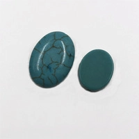 Detailed macro shot of oval turquoise stones with natural black webbed textures and polished finish