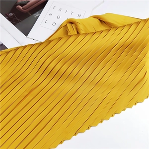 Vibrant yellow pleated scarf in rhombus shape with a glossy satin finish and elegant texture