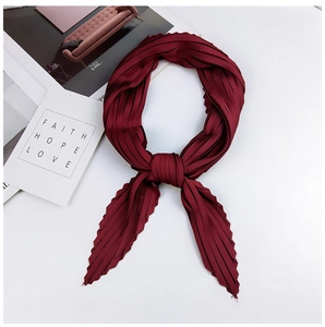 Close-up of wine red pleated silk scarf showing delicate accordion texture and fabric detail