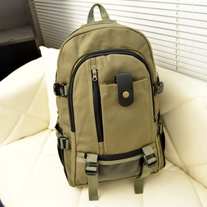 Vintage khaki canvas backpack with leather flap and brass buckles for outdoor hiking