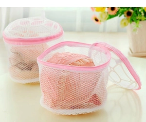 Close-up of two white mesh laundry bags with pink zippers for delicate bra protection