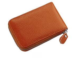 Side view of orange pebble leather card holder with premium silver zipper detail