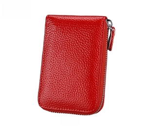 Detail of red litchi texture leather wallet with silver metal zipper closure