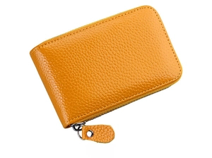 Side view of yellow pebble grain leather card holder featuring a smooth metal zipper