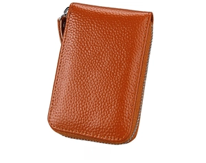 Detail view of orange-brown pebble leather card holder with secure silver metal zipper