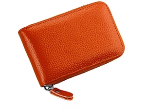 Side view of vibrant orange genuine leather credit card holder with silver zipper detail