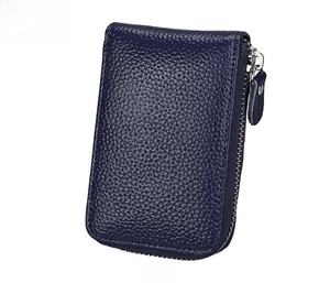 Close-up of deep blue leather wallet with lychee grain texture and silver zipper detail
