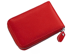 Close-up of red genuine leather card holder with litchi texture and metal zipper